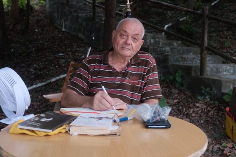 Italian missionary-turned-rights activist Franco Mella, 74, holds a three-day protest outside a maximum security jail in Hong Kong, refusing food and calling for the release of political prisoners, on Lantau Island overlooking Shek Pik Prison, July 13, 2022. Credit: RFA