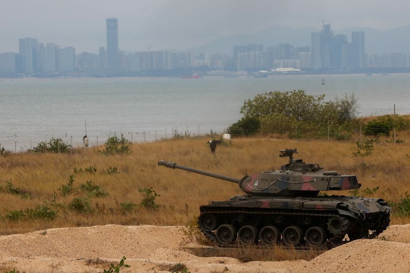 A retired military tank sits on the beach in Kinmen, with China in the background, Dec.r 20, 2023. (Ann Wang/Reuters)