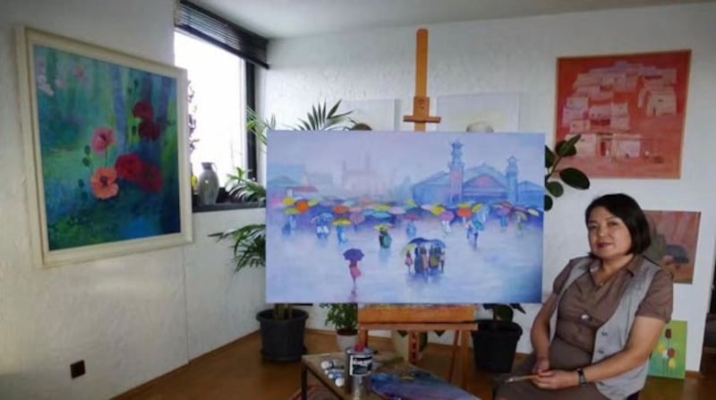 Uyghur artist Marwayit Hapiz with some of her works. Credit: Marwayit Hapiz