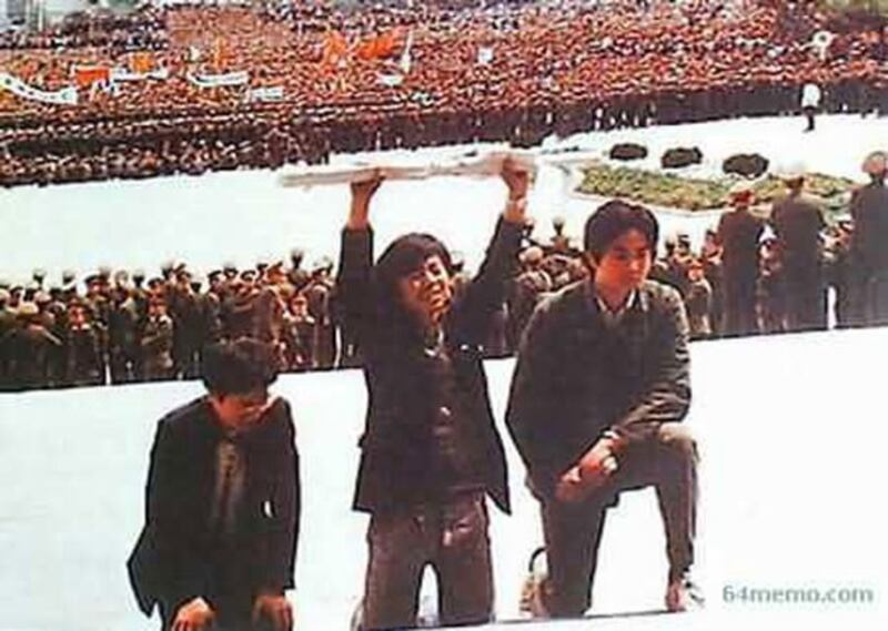 1989年4月22日12时，三名学生代表（左起张智勇、郭海峰、周勇军 ）在大会堂东门台阶跪递请愿书，长达45分钟。学生所有要求被拒绝：派代表参加追悼会、瞻仰遗容、灵车绕广场一周。（六四档案）