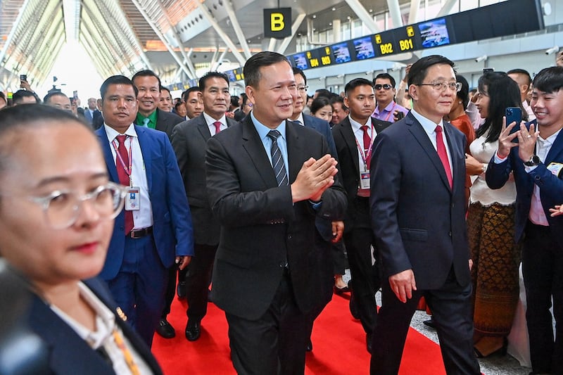 Cambodia's Prime Minister Hun Manet, center left, and China's Yunnan Province Governor Wang Yubo walk during the inauguration of the Chinese-funded Siem Reap-Angkor International Airport in Siem Reap province on Nov. 16, 2023. (Tang Chhin Sothy/AFP)