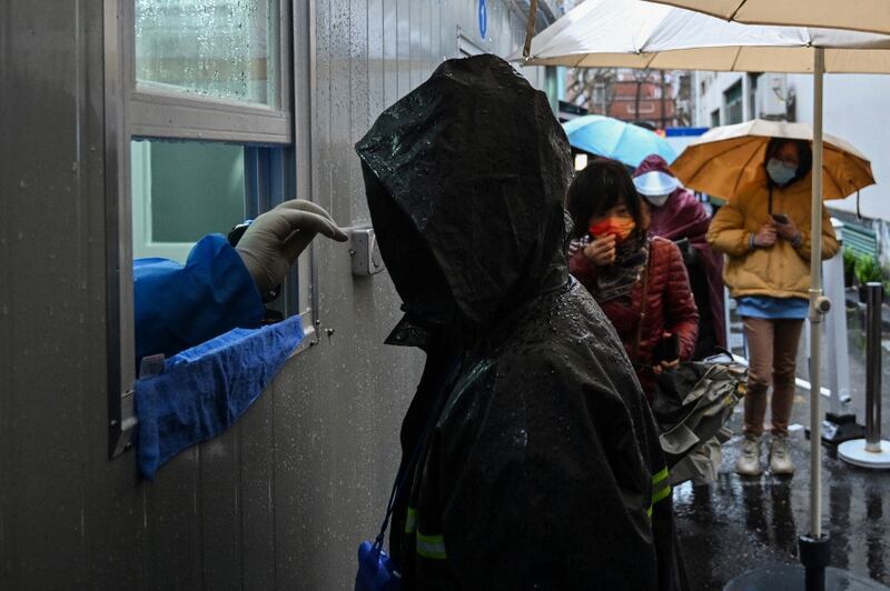 A man is tested as a measure against the Covid-19 coronavirus near the Shanghai Jin'an Central Hospital in Shanghai, March 21, 2022. Credit: AFP