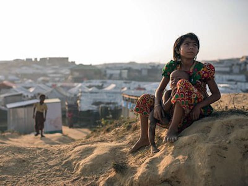 A Rohingya child refugee from Myanmar sits with a baby at the Kutupalong refugee camp in southeastern Bangladesh's Cox's Bazar district, Nov. 27, 2017. 