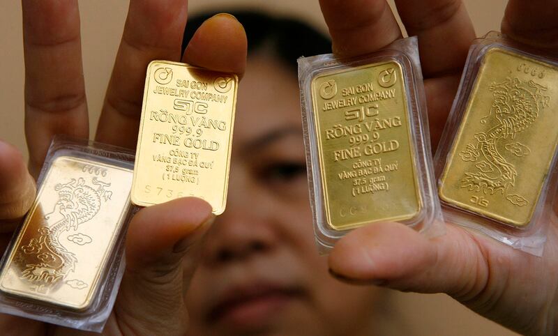 A woman displays gold at a shop in Hanoi, Oct. 11, 2009. (Kham/Reuters)