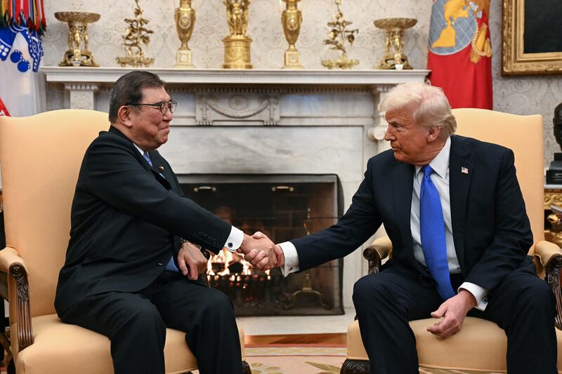 US President Donald Trump shakes hands with Japanese Prime Minister Shigeru Ishiba in the Oval Office of the White House in Washington, DC, on Feb. 7, 2025.