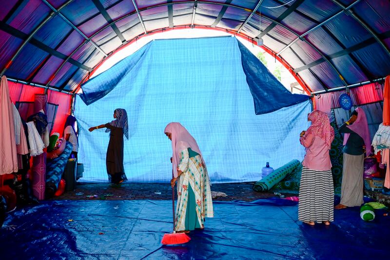 Fatima Khatun, a Rohingya survivor of a capsized refugee boat, cleans her temporary shelter in Meulaboh, Indonesia, on Wednesday, April 3, 2024. (Reza Saifullah/AP)