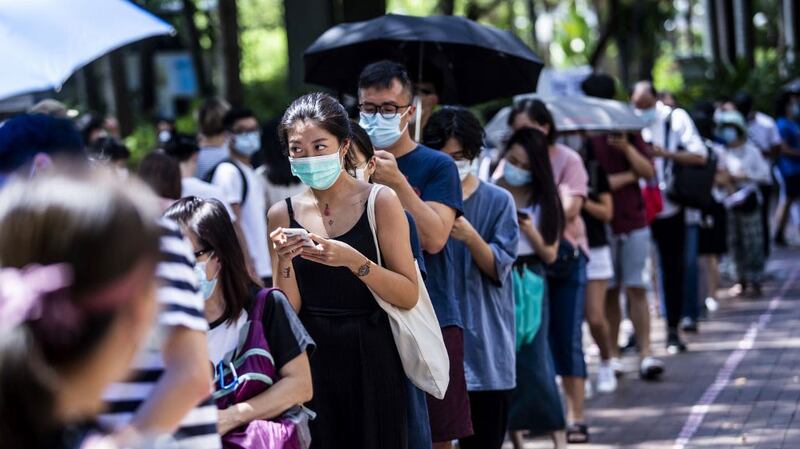 Voters line up to vote in primary elections as Hong Kong's pro-democracy parties held weekend primary polls to choose candidates for upcoming legislative elections, July 12, 2020.