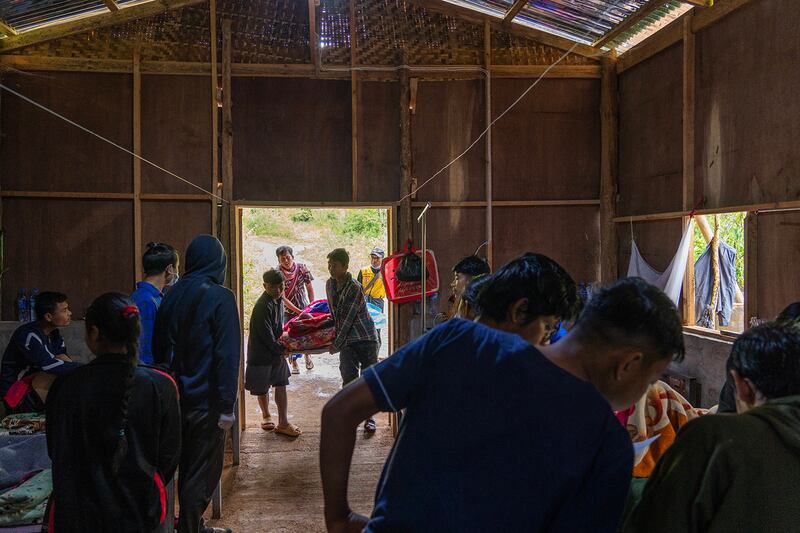 Karenni State Police officer Yar Zar Tun and others carry his wife, Zin Zin Aung, to a recovery ward after surgery at O-1 hospital in Demoso, Kayah state, Myanmar, Nov. 6, 2024.