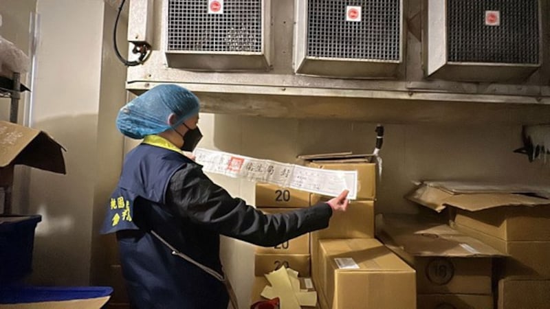 A municipal public health official from Taiwan's Taoyuan city inspects documentation after banned Sudan Red dye is found in chili powder from China, March 2024. (Taoyuan Municipal Health Bureau)