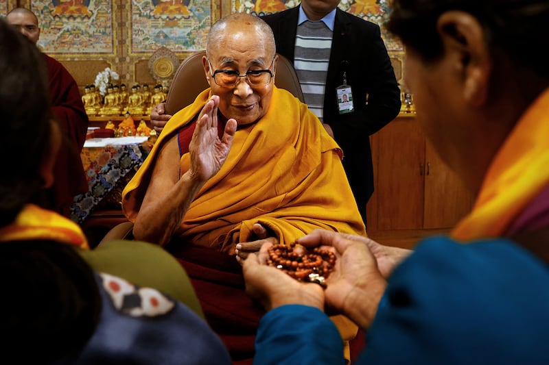 Tibetan spiritual leader, the Dalai Lama, offers blessings to his followers at his Himalayan residence in Dharamshala, India, December 20, 2024.