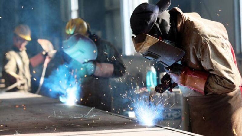 A worker cuts steel at a factory in Huaibei in eastern China's Anhui province, May 3, 2018.