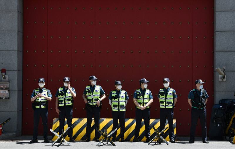 In this June 1, 2020 photo, policemen stand guard in front of the main gate of the Chinese embassy in Seoul as South Korean protesters demonstrate against a controversial new security law in Hong Kong close to the embassy. Credit: AFP Photo/Jung Yeon-je