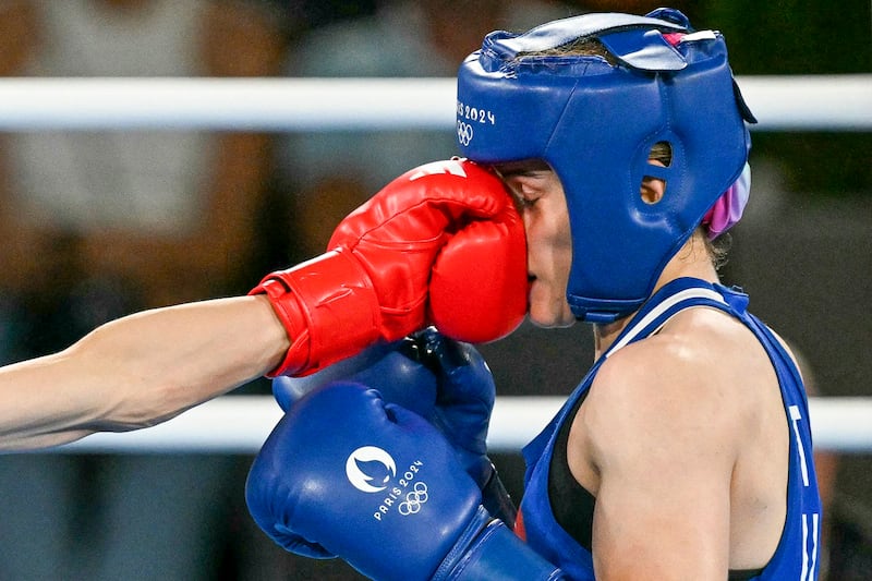 Taiwan's Lin Yu-ting and Turkey's Esra Yildiz Kahraman (Blue) compete in the women's 57kg semi-final boxing match during the Paris 2024 Olympic Games at the Roland-Garros Stadium, in Paris, Aug. 7, 2024. (Mohd Rasfan/AFP)