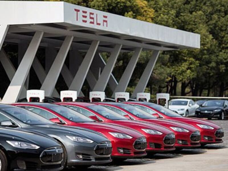 Tesla Model S electric vehicles are parked outside a car dealership in Shanghai, March 17, 2015.