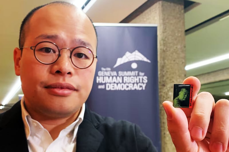 Sebastien Lai holds a lapel pin bearing an image of his father Jimmy Lai at the Human Rights and Democracy Summit in Geneva, Feb. 17, 2025.