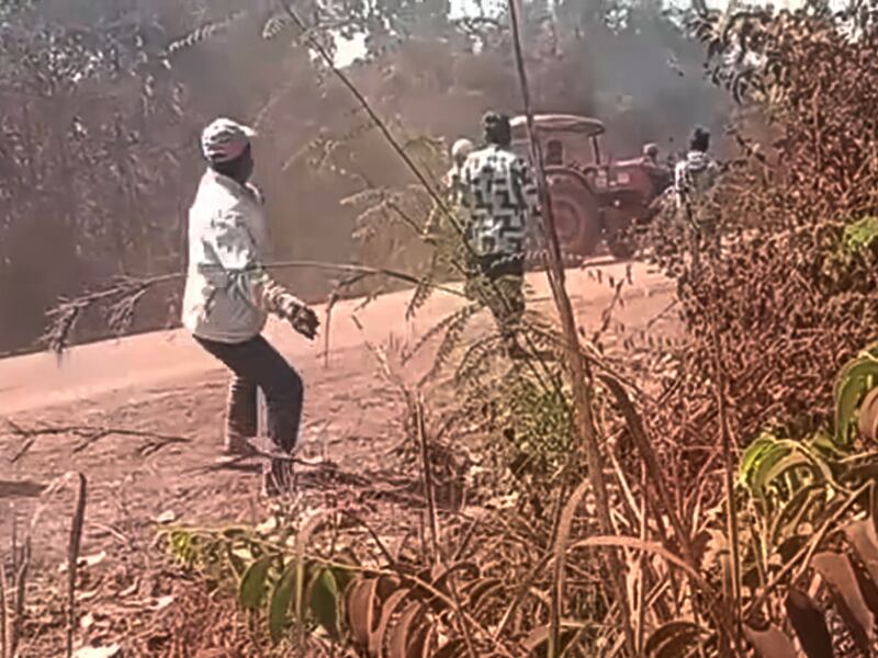 A man throws a rock at a Santana Agro Products Co. tractor in an attempt to prevent Santana Agro Products Co.  from clearing their forest and destroying their farmlands in Preah Vihear province, Cambodia, Jan. 28, 2025.