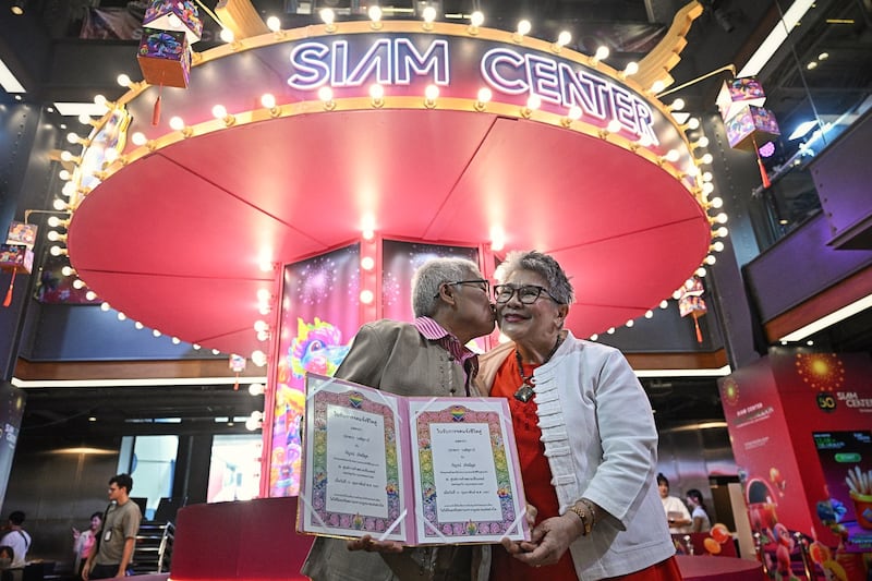 Kan Kerdmeemun (left) and Pakodchakon Wongsupha (right), who have been together for 30 years, pose for photos during a ceremony to unofficially wed LGBTQ+ couples on Valentine’s Day in Bangkok, Feb. 14, 2024. [Lillian Suwanrumpha/AFP]