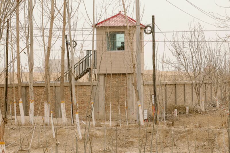 A security guard watches from a tower around a detention facility in Yarkent County in northwestern China's Xinjiang Uyghur Autonomous Region, March 21, 2021. (Ng Han Guan/AP)