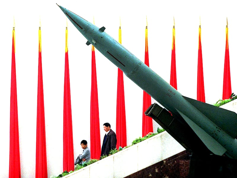 A couple walk past a missile on display at Beijing's Military Museum, April 25, 2001.