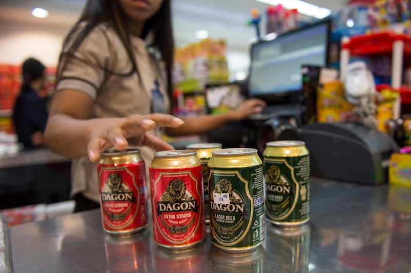 A cashier tallies the sale of Dagon Beer made by Myanmar junta owned Myanmar Economic Corporation, one of the country's main military conglomerates in Yangon, Sept. 2016. Credit: Romeo Gacad/AFP