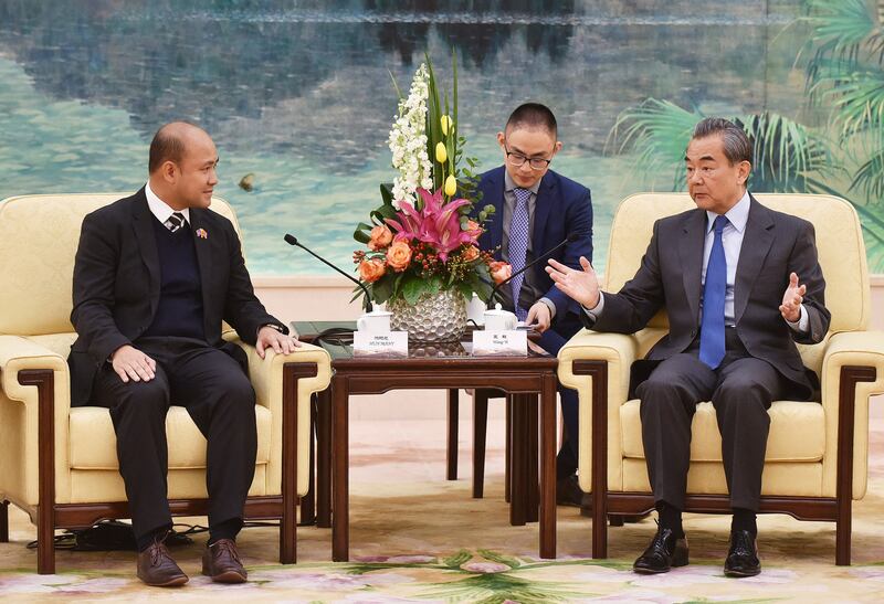 Hun Many, left, meets with China's Foreign Minister Wang Yi at the Great Hall of the People in Beijing on Dec. 6, 2018. (Greg Baker/Pool via AFP)