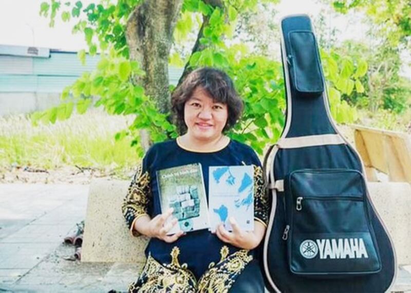 Pham Doan Trang displays the books she wrote that were banned by the Vietnamese government, in an undated photo from her Facebook page.