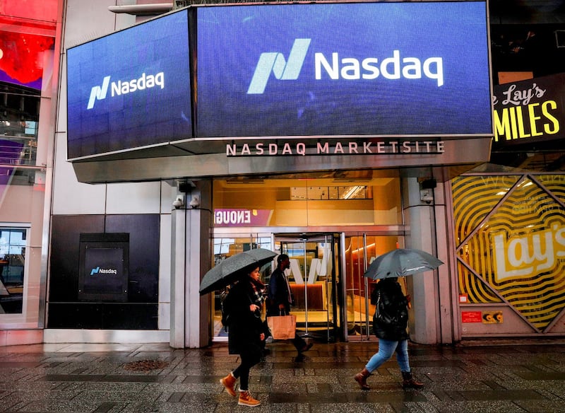 People pass by the Nasdaq Market Site in Times Square in New York City, U.S., Feb. 7, 2018. Credit: Reuters/Brendan McDermid