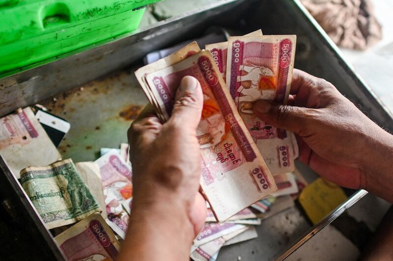 This year, Myanmar's kyat has lost 60 percent of its value against the dollar, briefly trading at a record low, below 4,000 kyat to the U.S. dollar, while the official conversion rate is 2,100. Credit: AFP