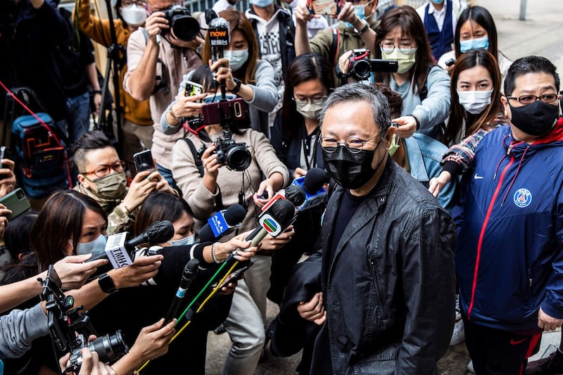 Pro-democracy activist Benny Tai [center] speaks to the media outside Ma On Shan police station in Hong Kong on Feb. 28, 2021. Credit: AFP