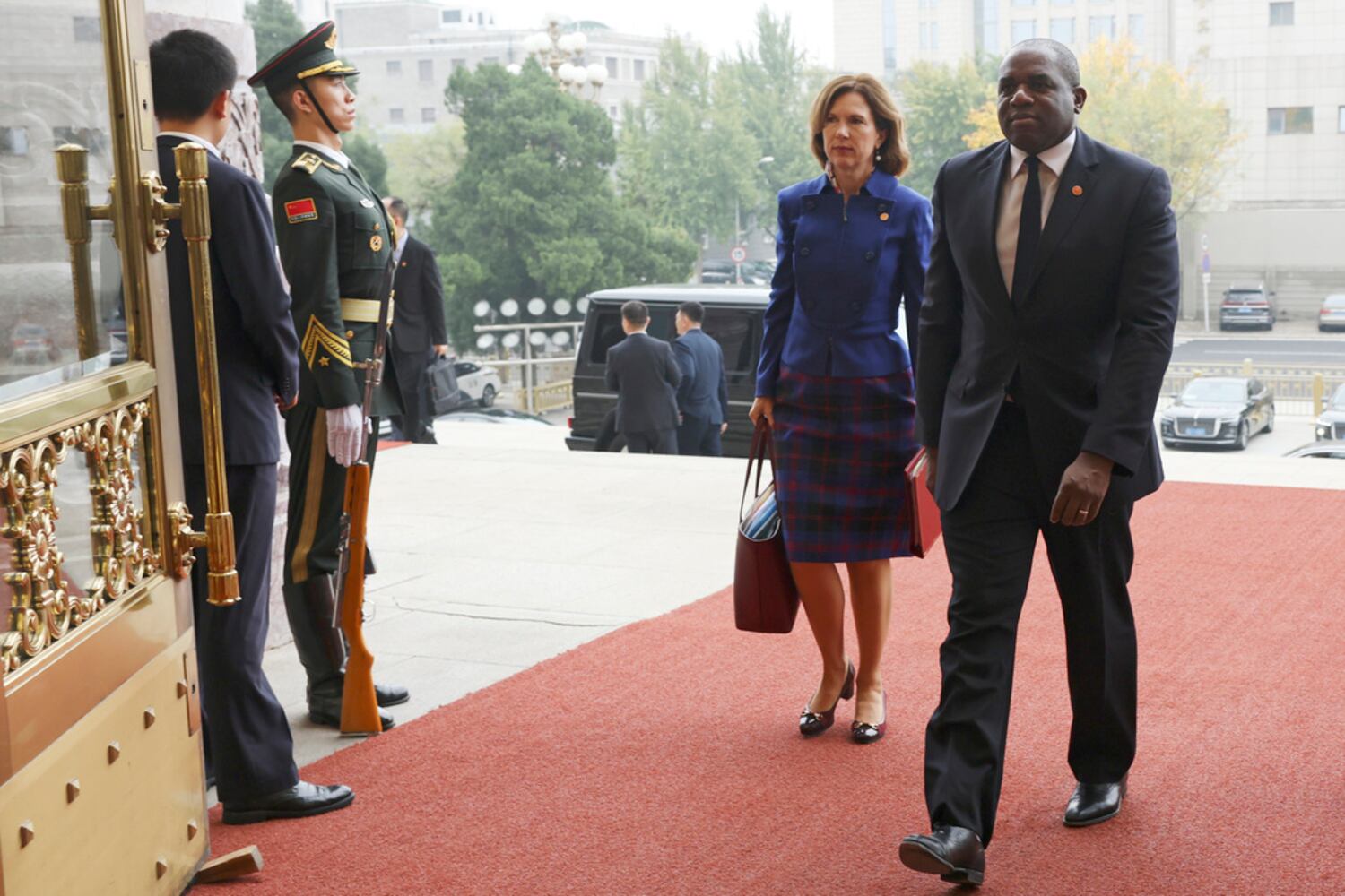 Britain's Foreign Secretary David Lammy (R) and British Ambassador to China Caroline Wilson arrive at the Great Hall of the People in Beijing, Oct. 18, 2024.