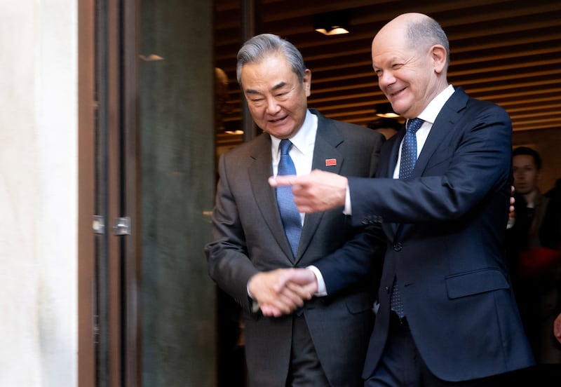 German Chancellor Olaf Scholz (R) and Chinese Foreign Minister Wang Yi attend the Munich Security Conference in Munich, Germany, Feb. 15, 2025.