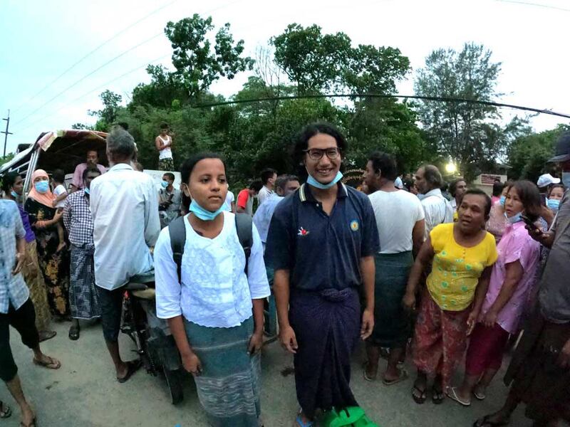 Journalists Kay Son Nway, left, and Ye Myo Khant stand together after their release from Insein Prison in Yangon on Wednesday. (Myo Min Soe/RFA)