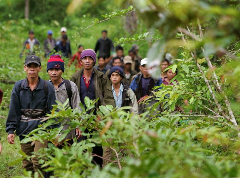 Montagnard hill tribesmen emerge from dense forest northeast of Ban Lung, in Cambodia's northeastern province of Ratanakiri July 22, 2004. Credit: Adrees Latif/Reuters