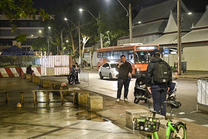 Central Investigation Bureau members stand near the spot where Lim Kimya, a former Cambodian MP, was shot in Bangkok on Jan. 7, 2025.