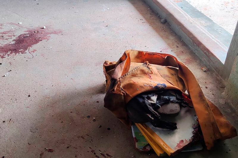 A school bag lies next to dried blood stains on the floor of a school in Let Yet Kone village in Tabayin township in the Sagaing region of Myanmar on Sept. 17, 2022, the day after a junta airstrike hit the school. Credit: Associated Press