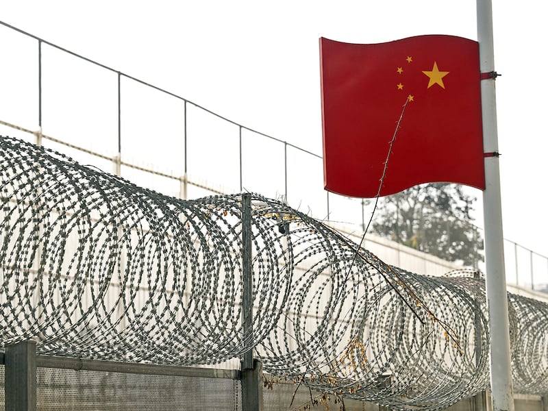 A Chinese flag flies over the border wall between China and Myanmar in Ruili, west Yunnan Province on Jan. 14, 2023.