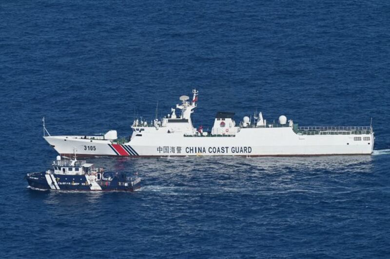 A China Coast Guard vessel (above) shadows the Philippines’ BRP Datu Tamblot during a mission to assist fishermen at the Scarborough Shoal in the disputed South China Sea,, Feb. 15, 2024. (Jam Sta Rosa/AFP)