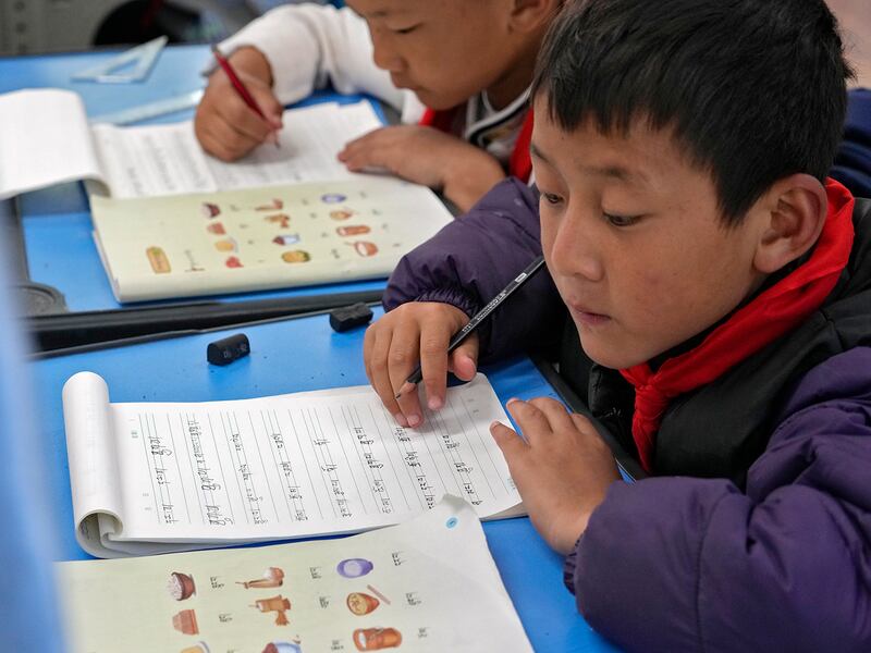 Tibetan students learn Tibetan writing in a first-grade class at the Shangri-La Key Boarding School in Dabpa county, Kardze Prefecture, Sichuan province, China on Sept. 5, 2023.