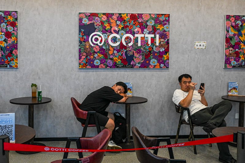 A man takes a nap at a COTTI coffee shop in Beijing, Aug. 1, 2024. Jade Gao/AFP)