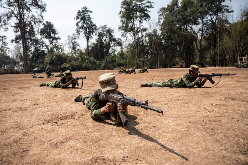 Ta'ang National Liberation Army soldiers take target practice at their base camp in the forest in Myanmar's northern Shan state, March 8, 2023. Credit: AFP