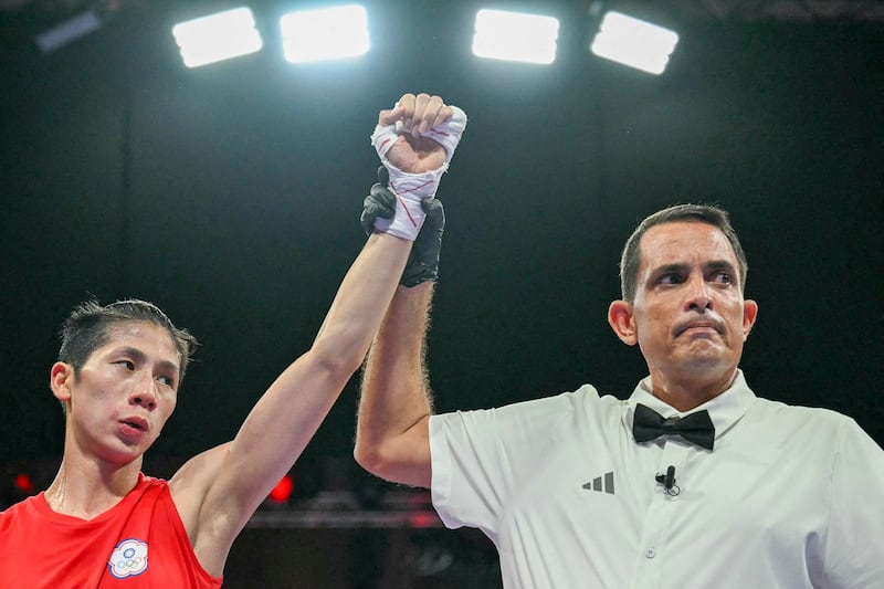 Taiwan's Lin Yu-ting (L) is declared victorious by Puerto Rico's referee Emanuel Ferreira at the end of her fight against Uzbekistan's Sitora Turdibekova in the women's 57kg preliminaries round of 16 boxing match during the Paris 2024 Olympic Games at the North Paris Arena, in Villepinte, Aug. 2, 2024. (Mohd Rasfan/AFP)