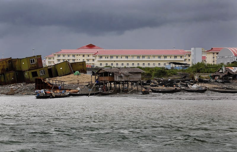 Local fishermen's houses and boats at the foreground of the Chinese oil pipeline project building on Maday island, Kyaukpyu township, Rakhine state, Myanmar Oct. 7, 2015. Credit: Soe Zeya Tun/Reuters