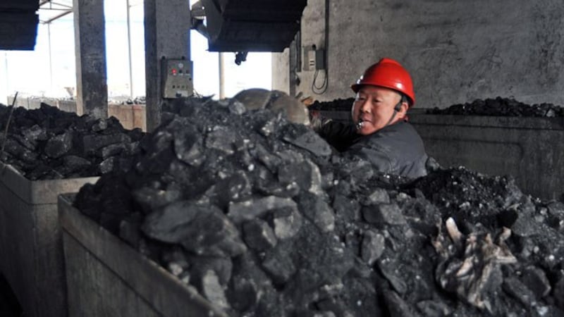 A Chinese laborer works in a coal mining facility in Huaibei, northern China's Anhui province, in a file photo.