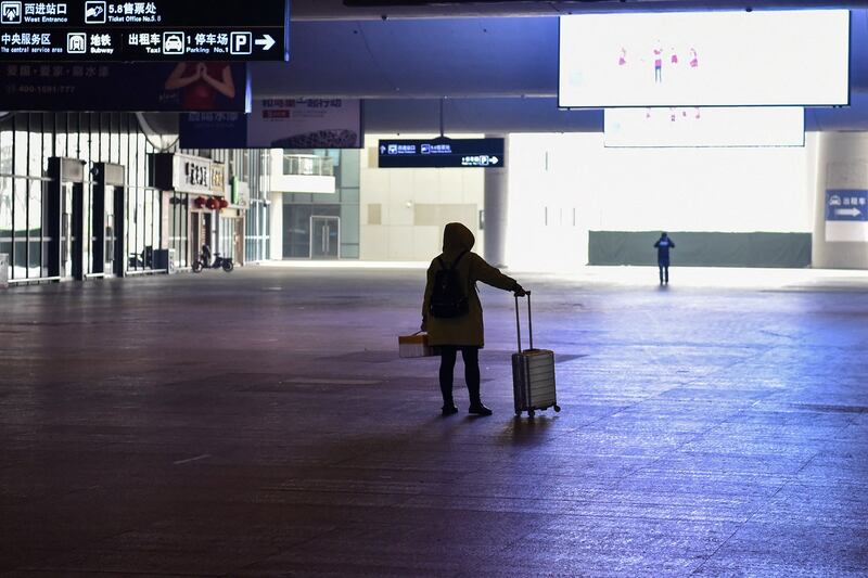 A passenger arrives at the nearly deserted Wuhan train station, usually full of passengers ahead of the Lunar New Year, on Jan. 23, 2020. (Hector Retamal/AFP)