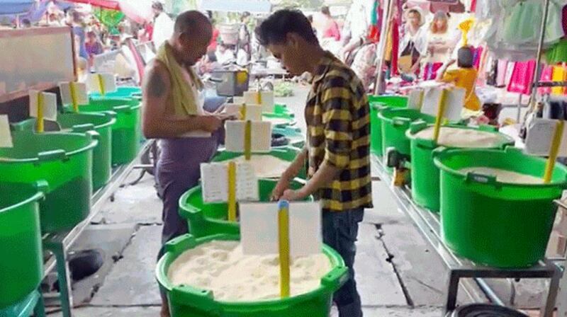 Buckets of rice are seen at a rice shop in Yangon, Myanmar, April 12, 2022. Credit: RFA