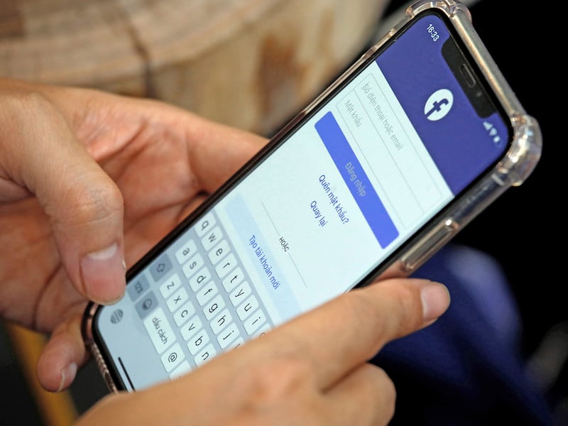 A Facebook user logs in on his mobile at a cafe in Hanoi, Vietnam Nov. 19, 2020.