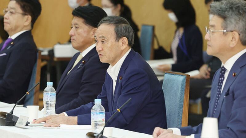 Japan's Prime Minister Yoshihide Suga (C) speaks next to Japan's chief cabinet secretary Katsunobu Kato (L), Japan's minister in charge of digital reform Takuya Hirai (2nd L) and Japan's internal affairs and communications minister Ryota Takeda (L) at a meeting on digital reform in Tokyo, Sept. 25, 2020.