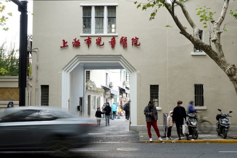 People stand outside a children's hospital in Shanghai, China, Nov. 24, 2023. Credit: Nicoco Chan/Reuters