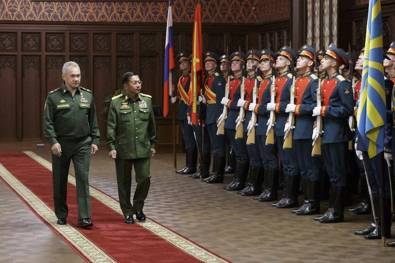 This handout picture taken on June 22, 2021 and released by the Russian Defence Ministry on June 23, 2021, shows Russian Defense Minister Sergei Shoigu (L) and Commander-in-Chief of Myanmar's armed forces, Senior General Min Aung Hlaing as they walk past the honor guard prior to their talks in Moscow. Credit: AFP