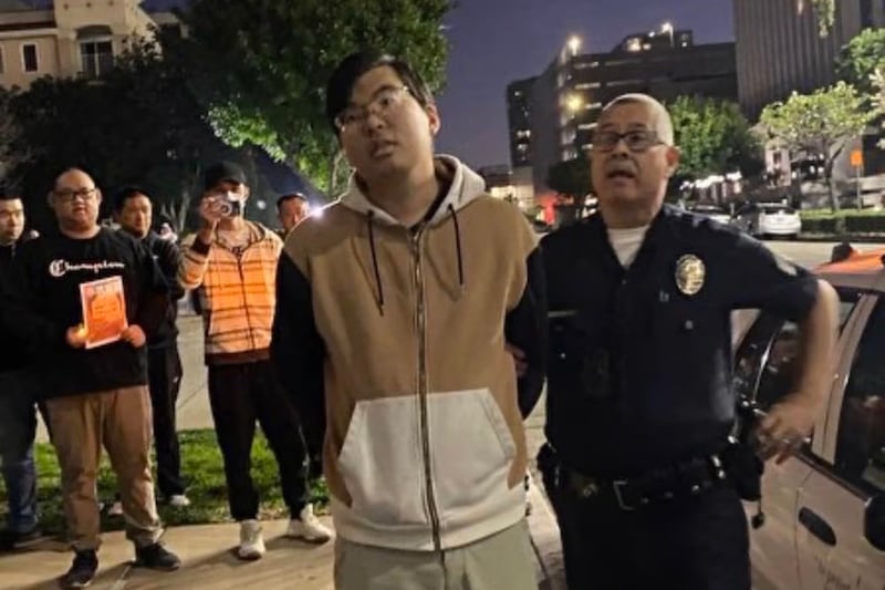 California police arrest a man at an event honoring late Wuhan doctor Li Wenliang after he man smashed some of the materials used by protesters, in 2023.